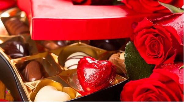 A charming Valentine's Day gift basket featuring an assortment of chocolates and a cuddly teddy bear, perfect for expressing love